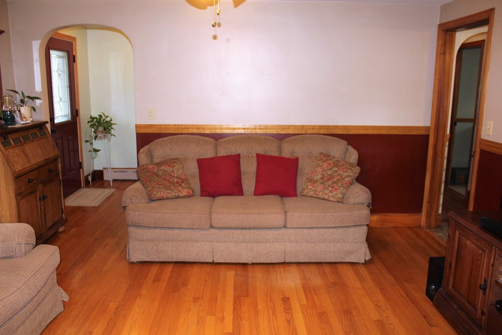 65 Primrose Street Springfield, MA 01151 - Photo 19 of 30 a living room with couches bookshelf and a flat screen tv