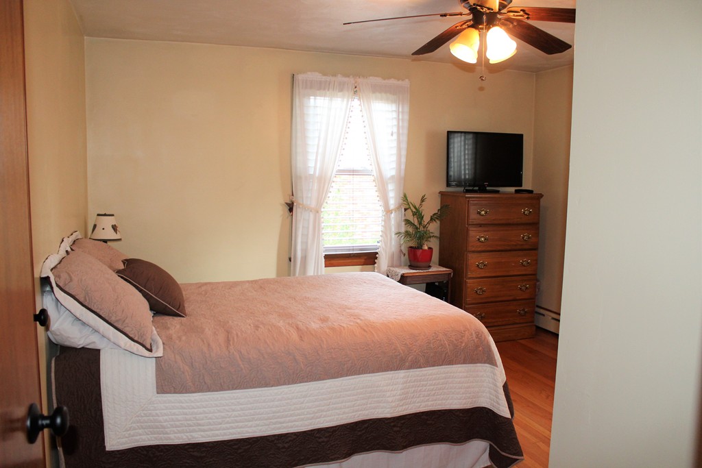 65 Primrose Street Springfield, MA 01151 - Photo 21 of 30 a bedroom with a bed and a flat screen tv