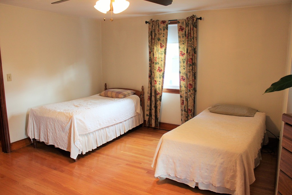 65 Primrose Street Springfield, MA 01151 - Photo 27 of 30 a bedroom with a bed and a chandelier