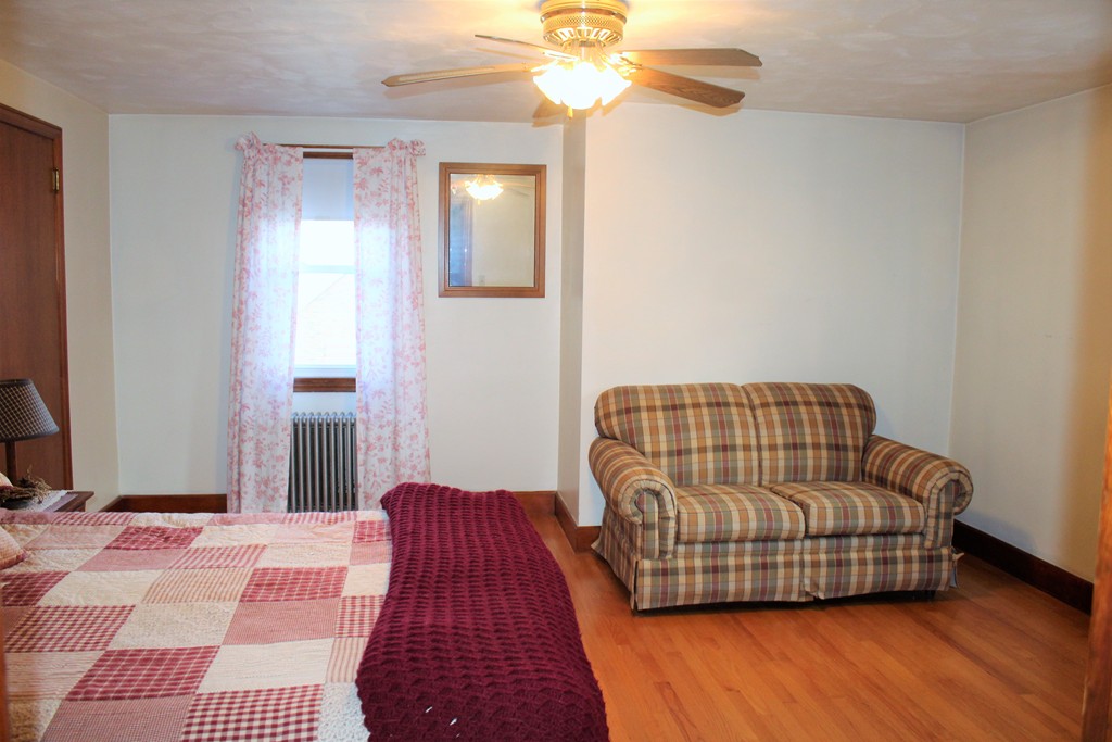 65 Primrose Street Springfield, MA 01151 - Photo 29 of 30 a living room with a couch and chandelier