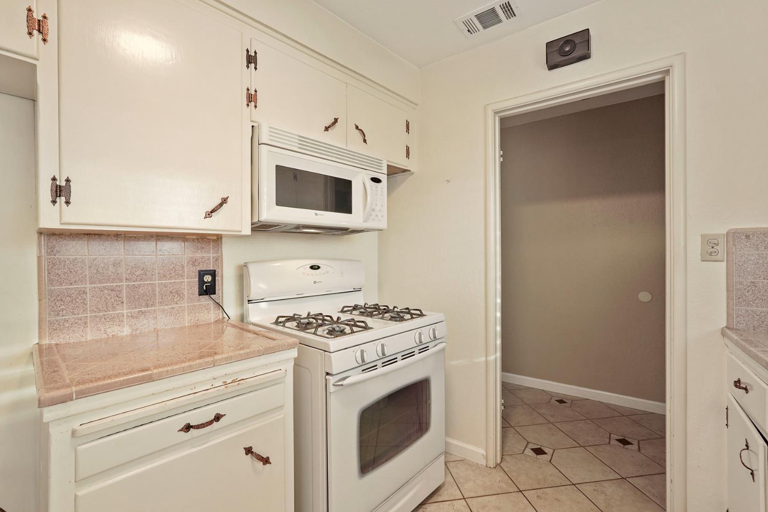 1007 Cardinal Street Lodi, CA 95240 - Photo 11 of 31 a kitchen with cabinets and appliances