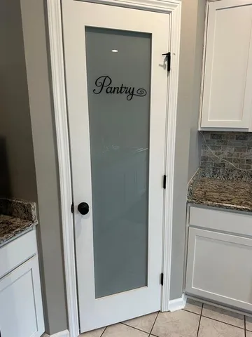 a kitchen with a table chairs and a refrigerator