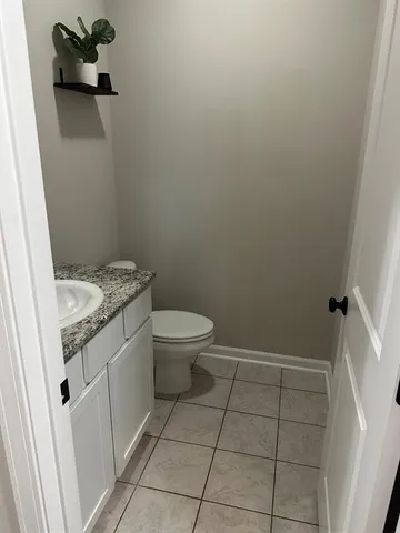 a kitchen with granite countertop kitchen island stainless steel appliances a sink stove and refrigerator