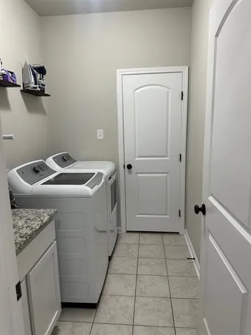 a bathroom with a granite countertop toilet and sink