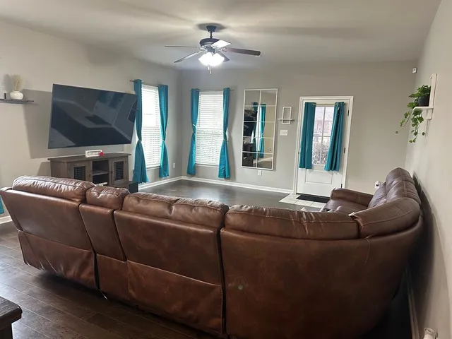 a living room with furniture and a flat screen tv