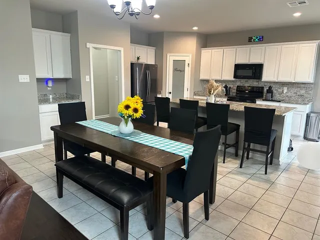 a kitchen with a dining table and chairs