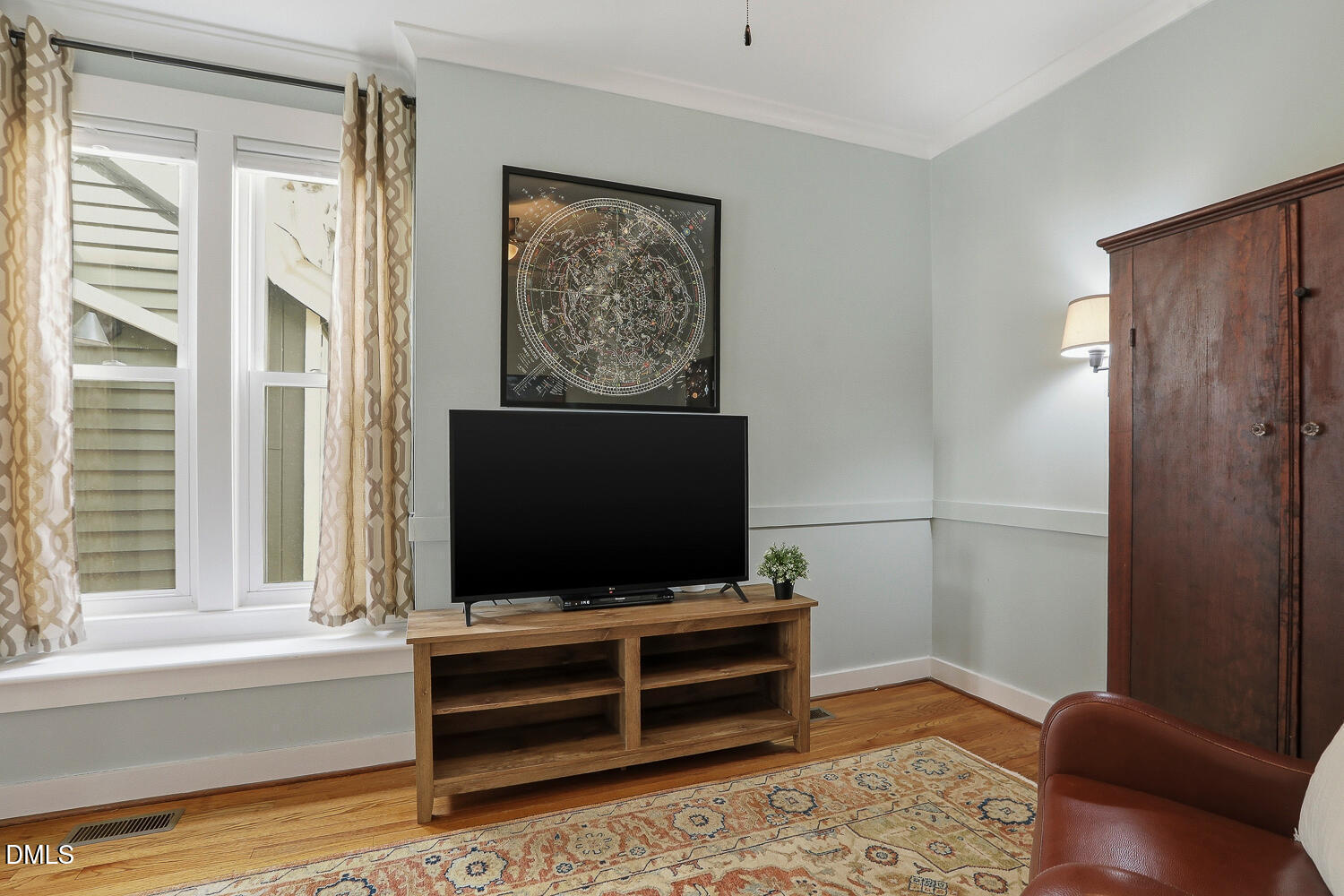 6023 Sentinel Drive Raleigh, NC 27609 - Photo 23 of 53 a living room with a flat screen tv and a window