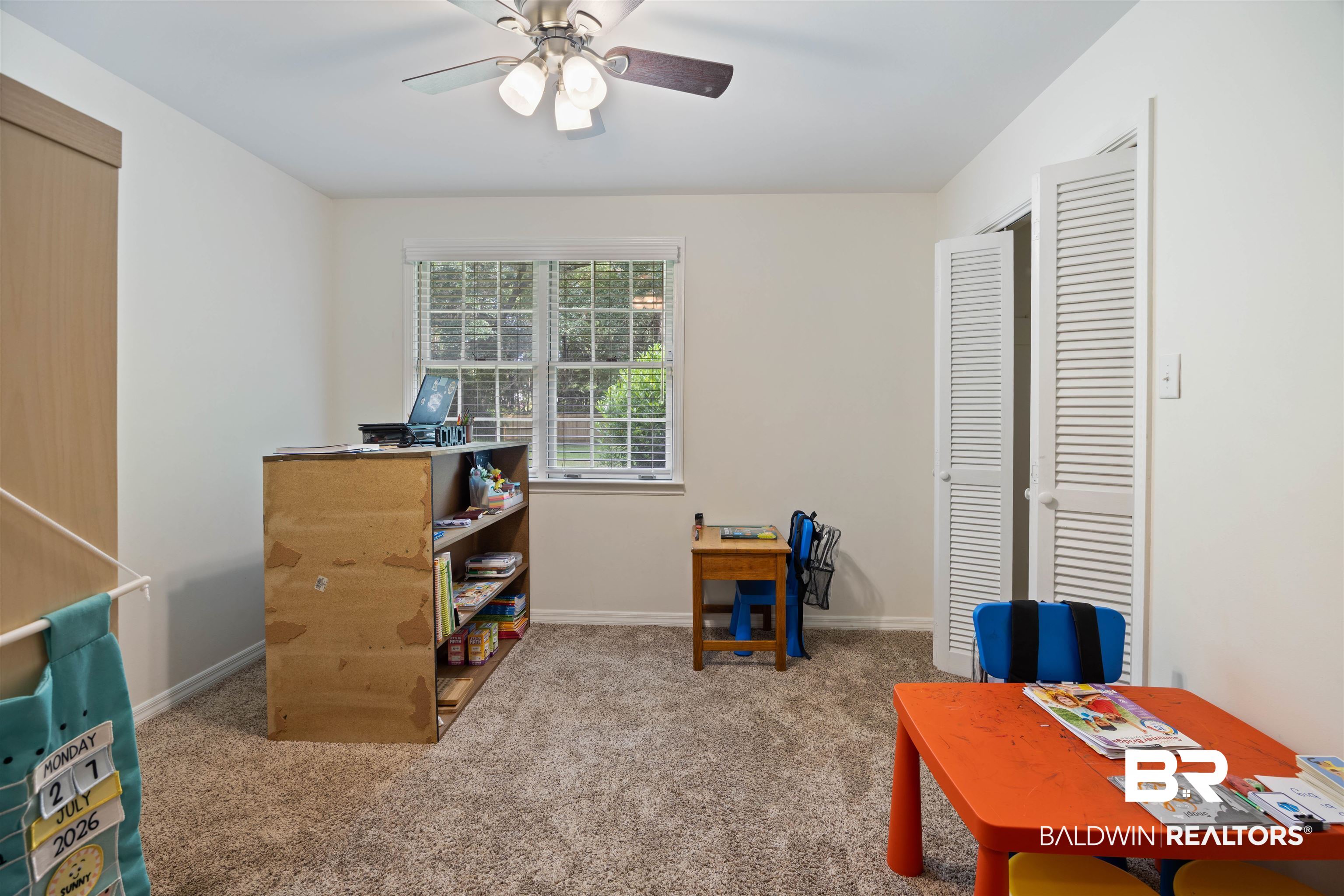 13677 Rebel Road Coden, AL 36523 - Photo 20 of 61 Carpeted room with a ceiling fan, a window featuring blinds, and bi-fold louvered doors