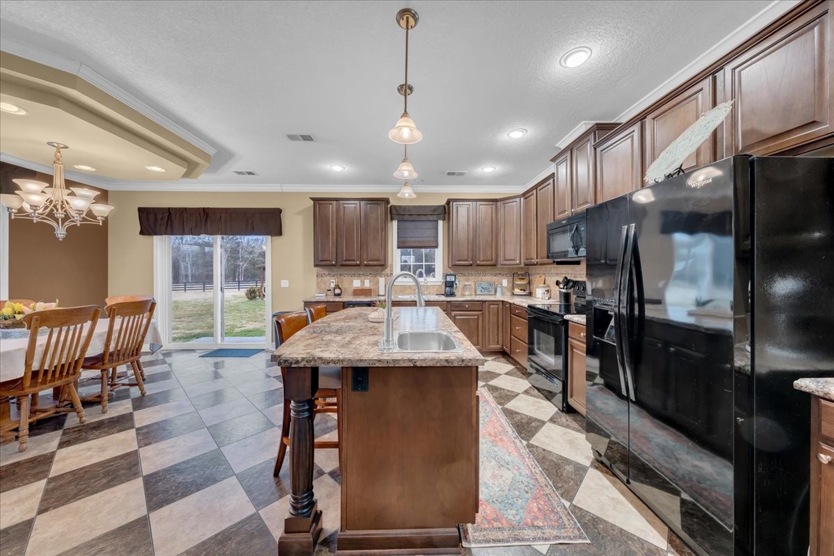 1798 Holly Grove Road Lewisburg, TN 37091 - Photo 12 of 55 a kitchen with stainless steel appliances granite countertop a sink refrigerator and cabinets