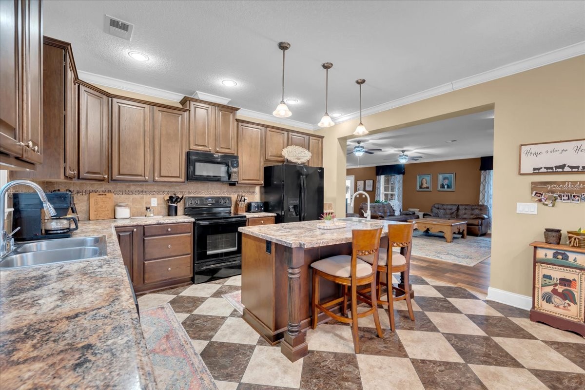 1798 Holly Grove Road Lewisburg, TN 37091 - Photo 15 of 55 a kitchen with a sink a counter top space appliances and cabinets