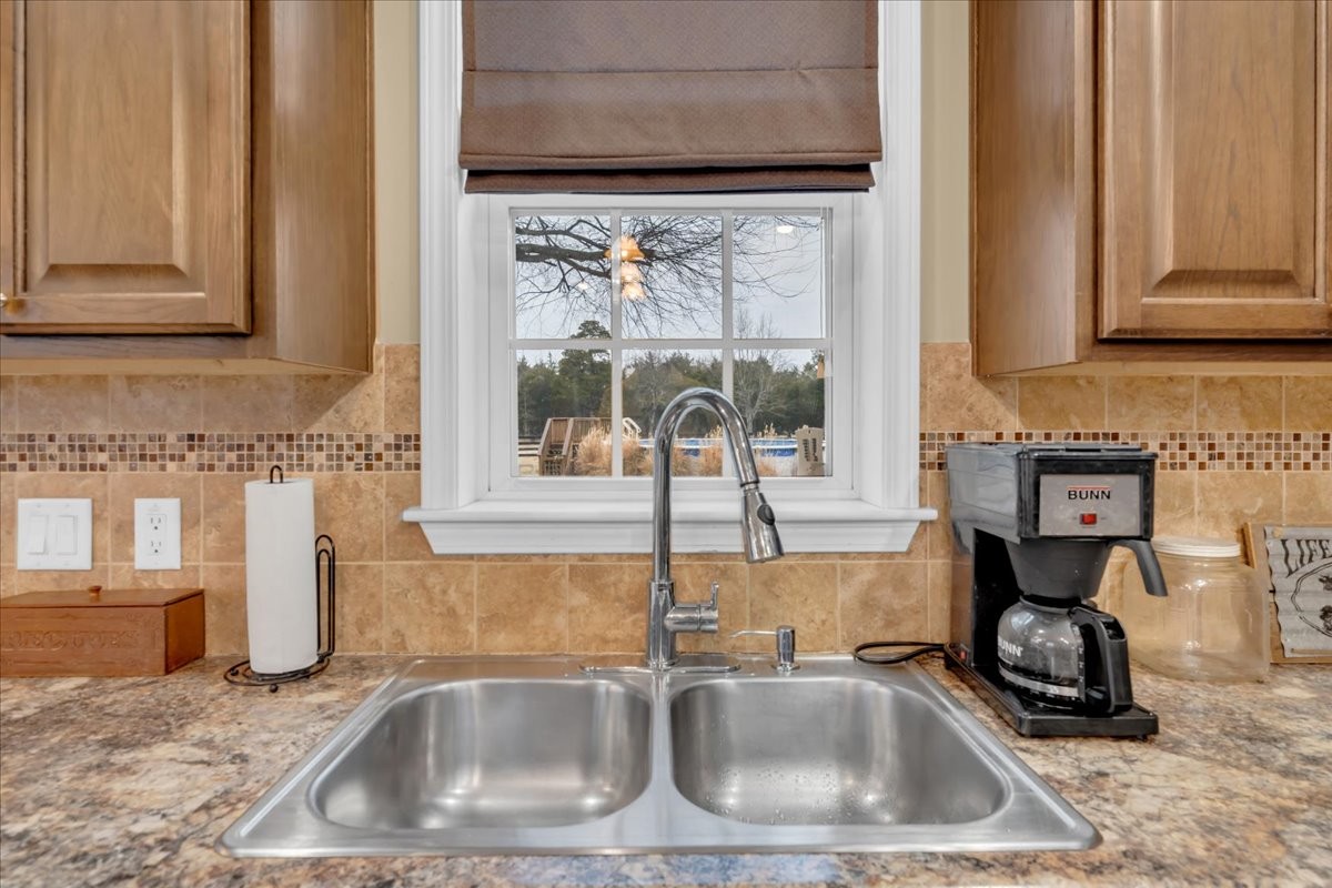 1798 Holly Grove Road Lewisburg, TN 37091 - Photo 17 of 55 a kitchen sink with a granite countertop a sink and cabinets next to a window