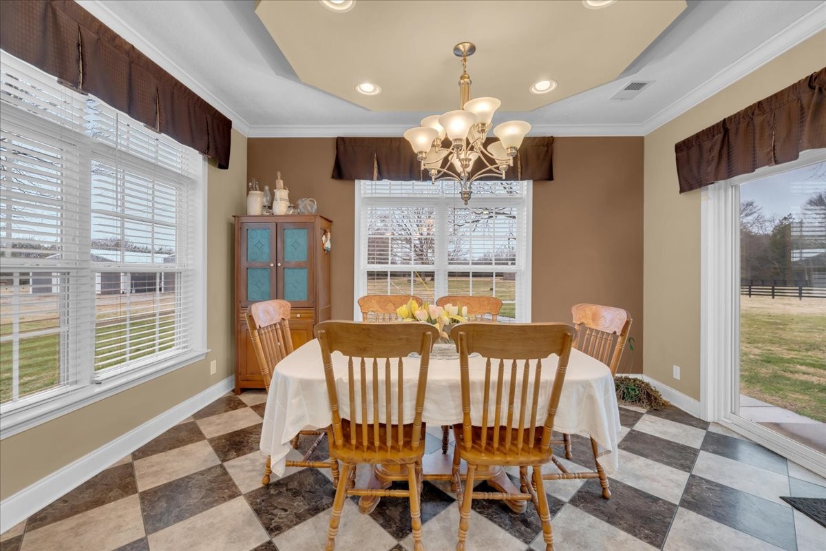 1798 Holly Grove Road Lewisburg, TN 37091 - Photo 20 of 55 a view of a dining room with furniture a chandelier and wooden floor