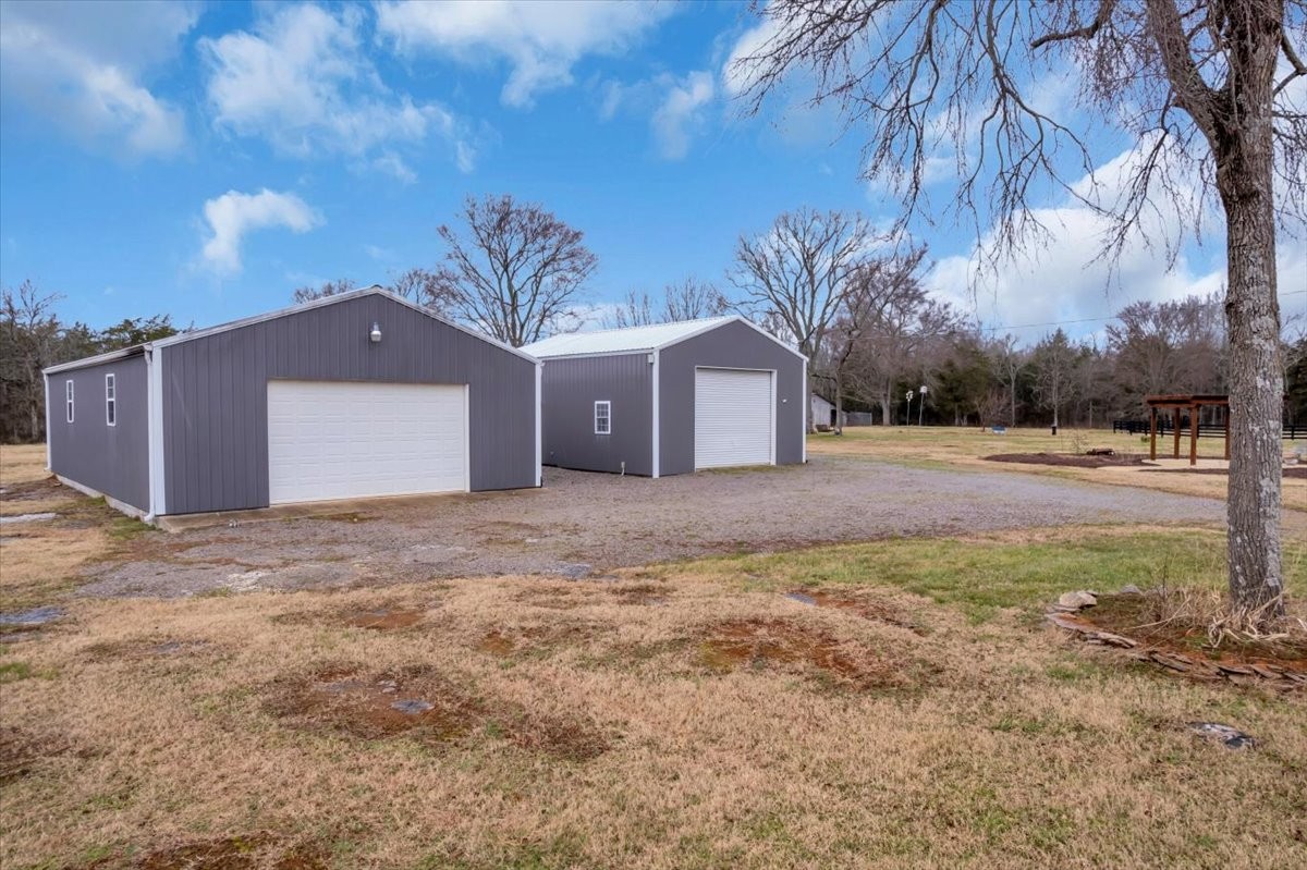 1798 Holly Grove Road Lewisburg, TN 37091 - Photo 47 of 55 a front view of a house with a yard and garage