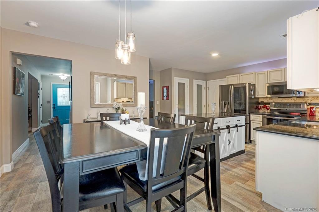 1433 Autumn Ridge Lane Fort Mill, SC 29708 - Photo 12 of 38 a view of a dining room with furniture and wooden floor