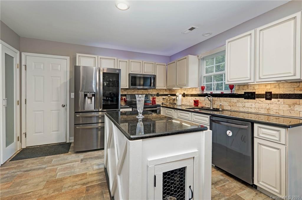 1433 Autumn Ridge Lane Fort Mill, SC 29708 - Photo 13 of 38 a kitchen with a sink stove and refrigerator