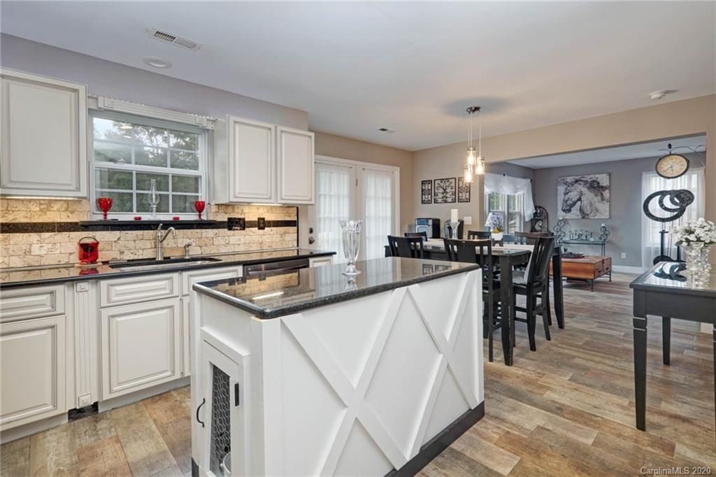 1433 Autumn Ridge Lane Fort Mill, SC 29708 - Photo 15 of 38 a kitchen with granite countertop a sink stove and cabinets