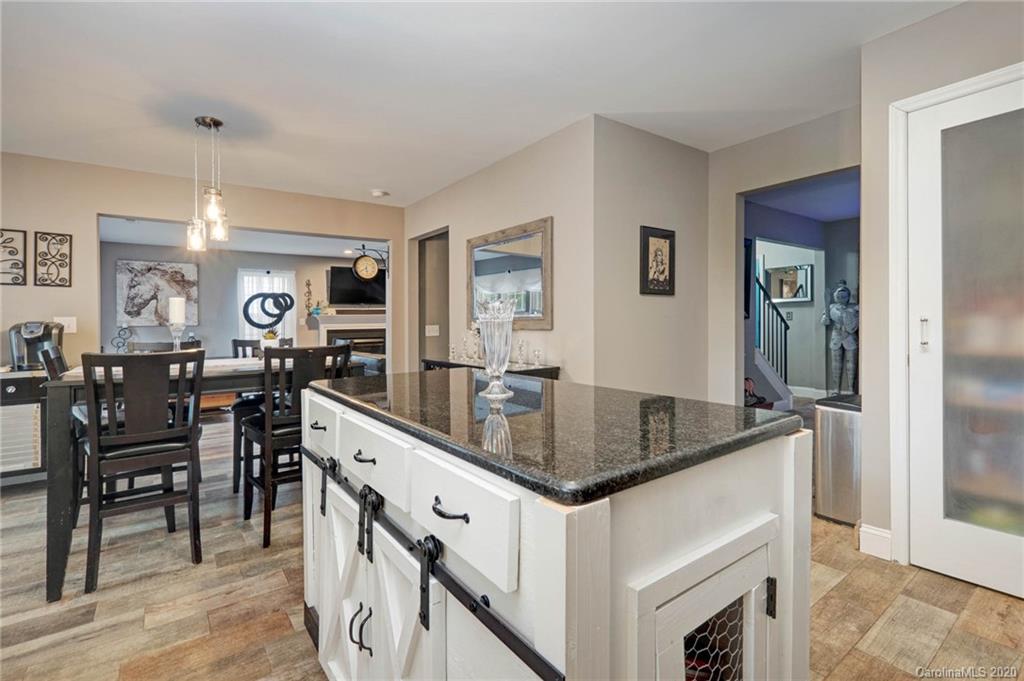1433 Autumn Ridge Lane Fort Mill, SC 29708 - Photo 16 of 38 a kitchen with center island table and chairs