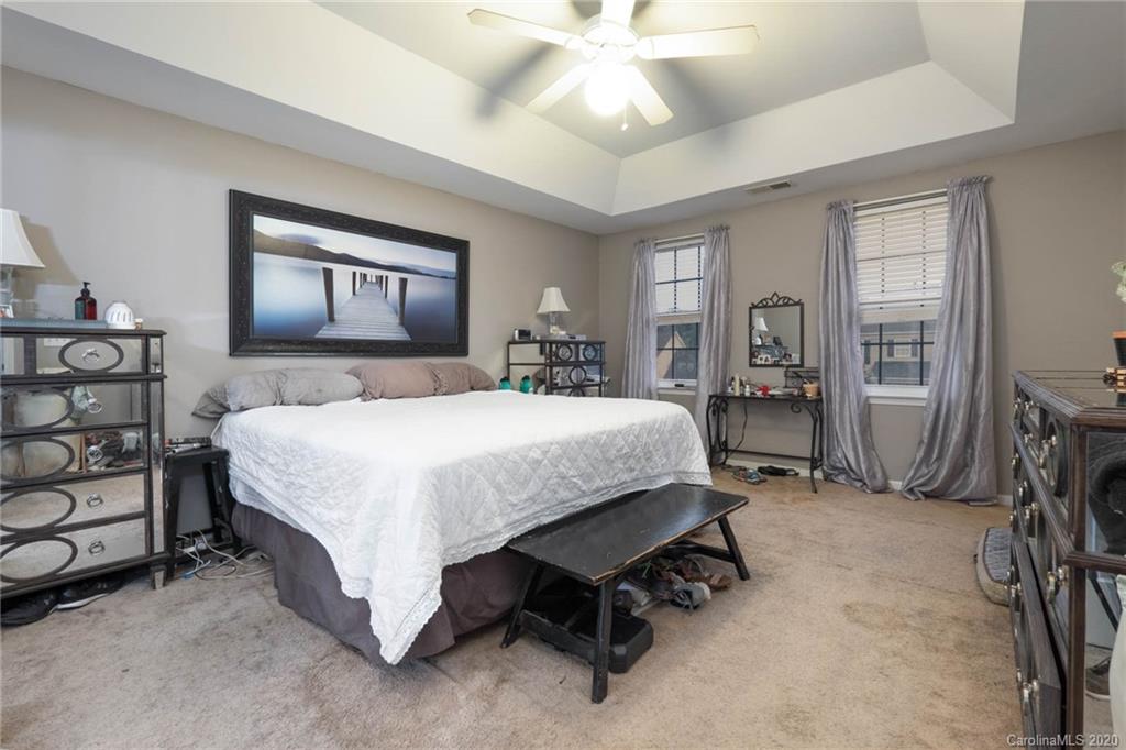 1433 Autumn Ridge Lane Fort Mill, SC 29708 - Photo 20 of 38 a bedroom with a bed and a chandelier