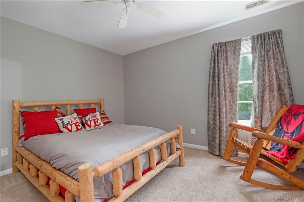 1433 Autumn Ridge Lane Fort Mill, SC 29708 - Photo 28 of 38 a bedroom with a bed and a couch