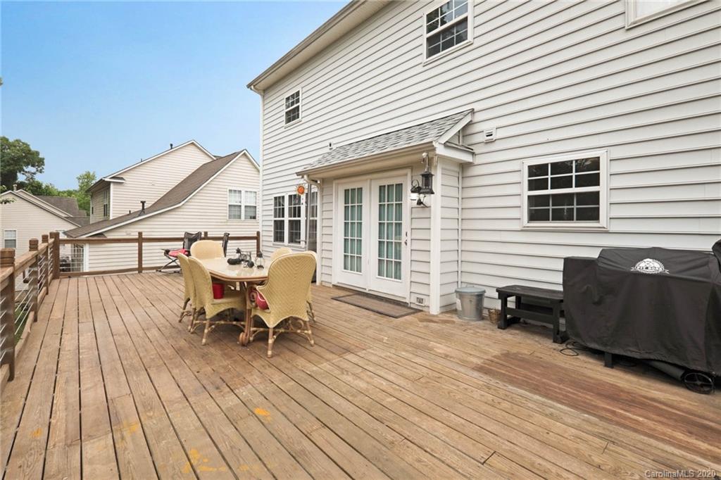 1433 Autumn Ridge Lane Fort Mill, SC 29708 - Photo 32 of 38 a view of a roof deck with table and chairs and wooden floor