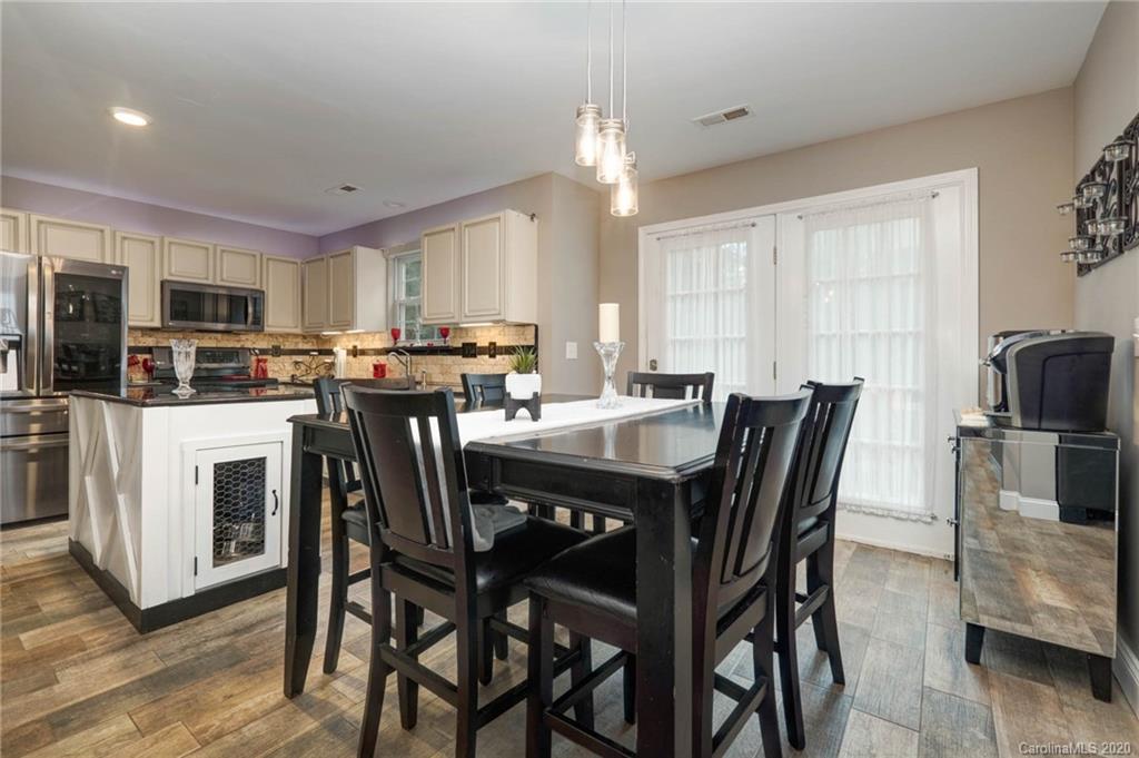 1433 Autumn Ridge Lane Fort Mill, SC 29708 - Photo 10 of 38 a view of a dining room with furniture and wooden floor