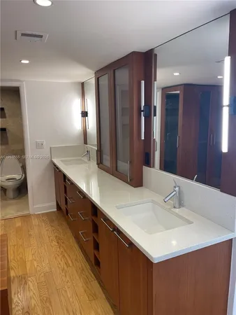 a bathroom with a sink double vanity and a mirror