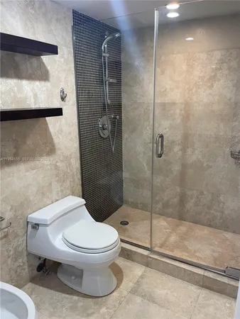a white toilet next to a bathroom sink