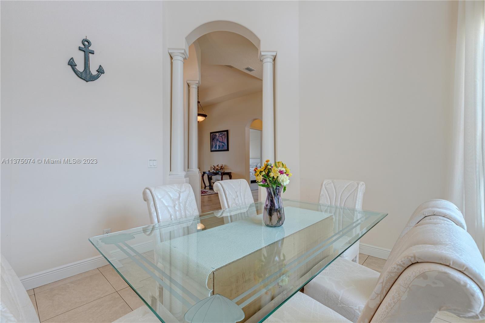 258 Bimini Road Cocoa Beach, FL 32931 - Photo 12 of 43 a view of a dining room with furniture