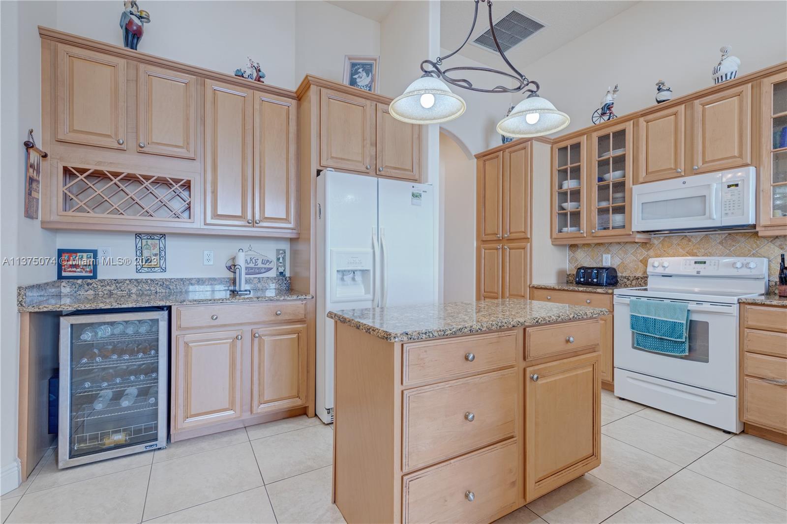 258 Bimini Road Cocoa Beach, FL 32931 - Photo 16 of 43 a kitchen with stainless steel appliances granite countertop a stove and cabinets