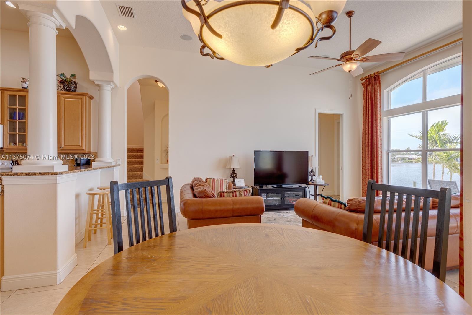 258 Bimini Road Cocoa Beach, FL 32931 - Photo 18 of 43 a living room with furniture fireplace and a large window