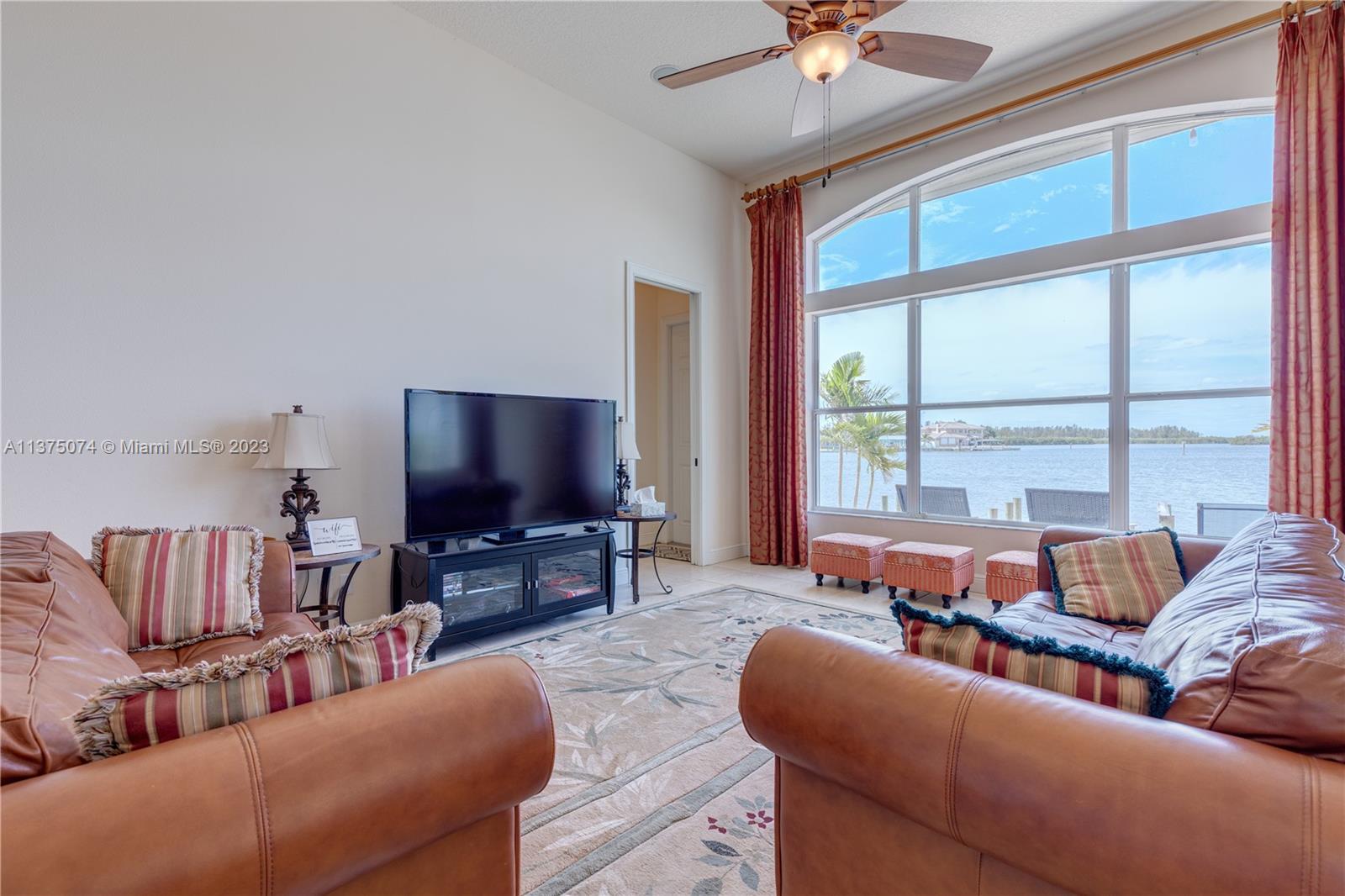 258 Bimini Road Cocoa Beach, FL 32931 - Photo 19 of 43 a living room with furniture and a flat screen tv