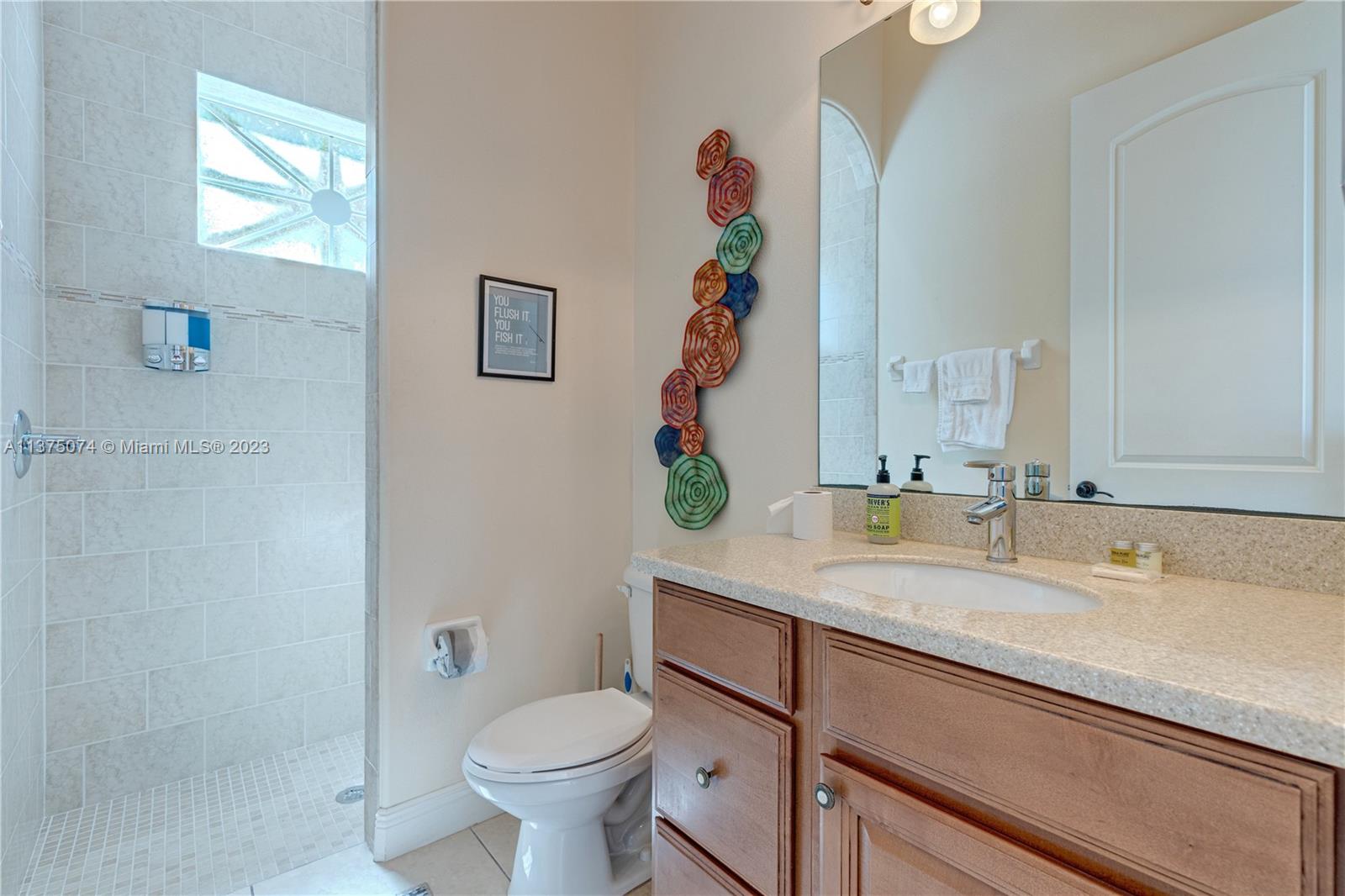258 Bimini Road Cocoa Beach, FL 32931 - Photo 22 of 43 a bathroom with a sink and a toilet