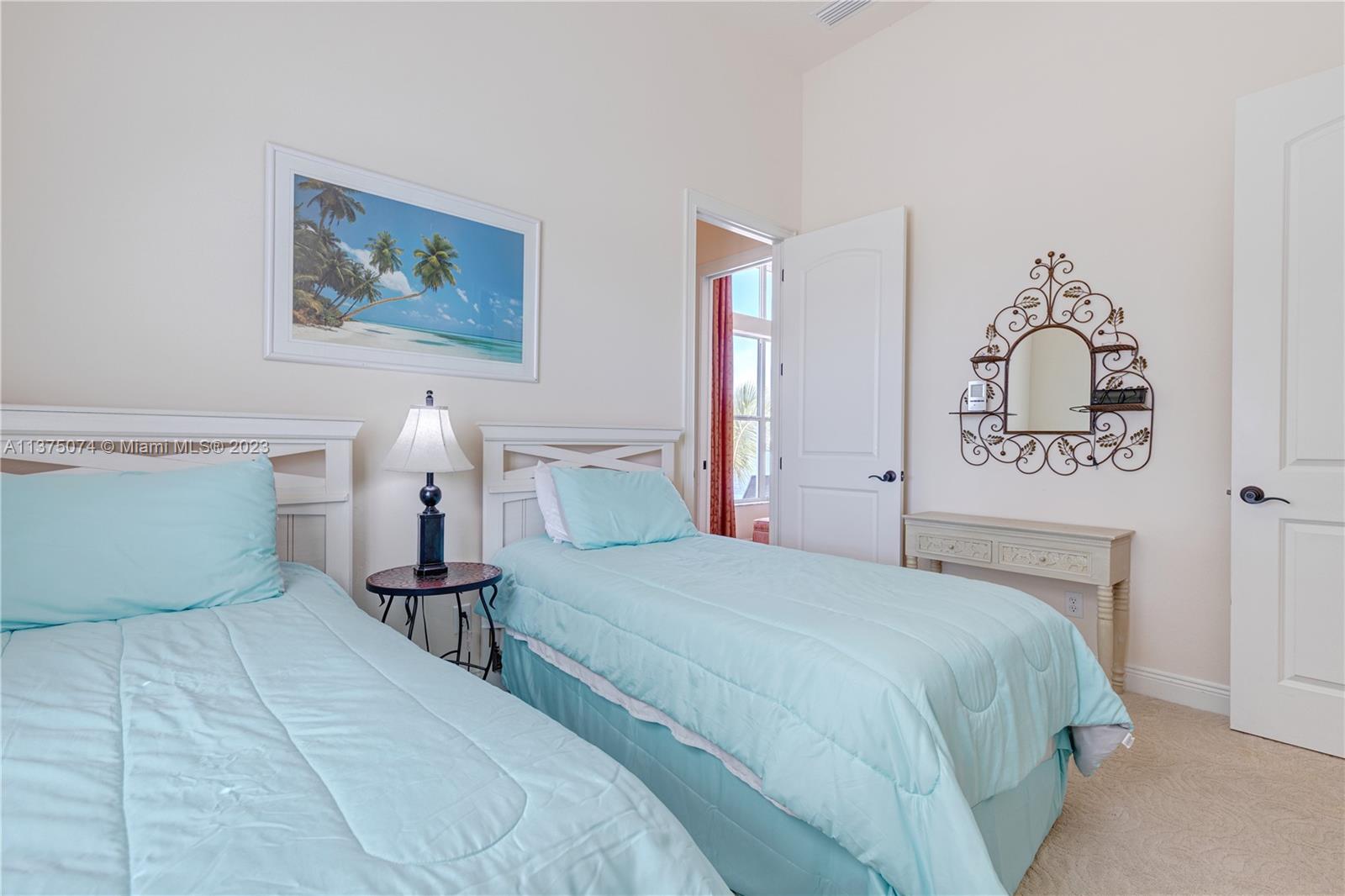258 Bimini Road Cocoa Beach, FL 32931 - Photo 24 of 43 a bedroom with a bed and lamp
