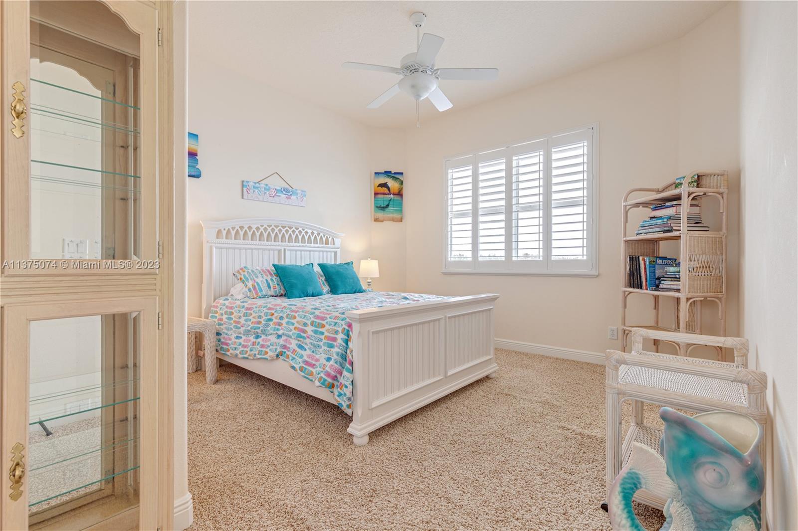 258 Bimini Road Cocoa Beach, FL 32931 - Photo 29 of 43 a bedroom with a bed and a window