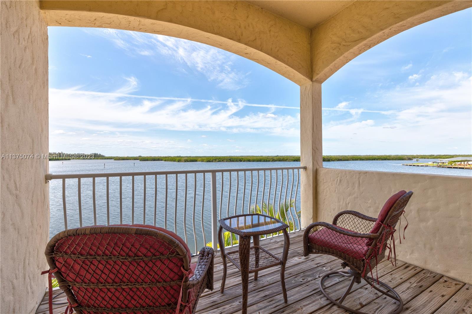 258 Bimini Road Cocoa Beach, FL 32931 - Photo 32 of 43 a balcony with table and chairs