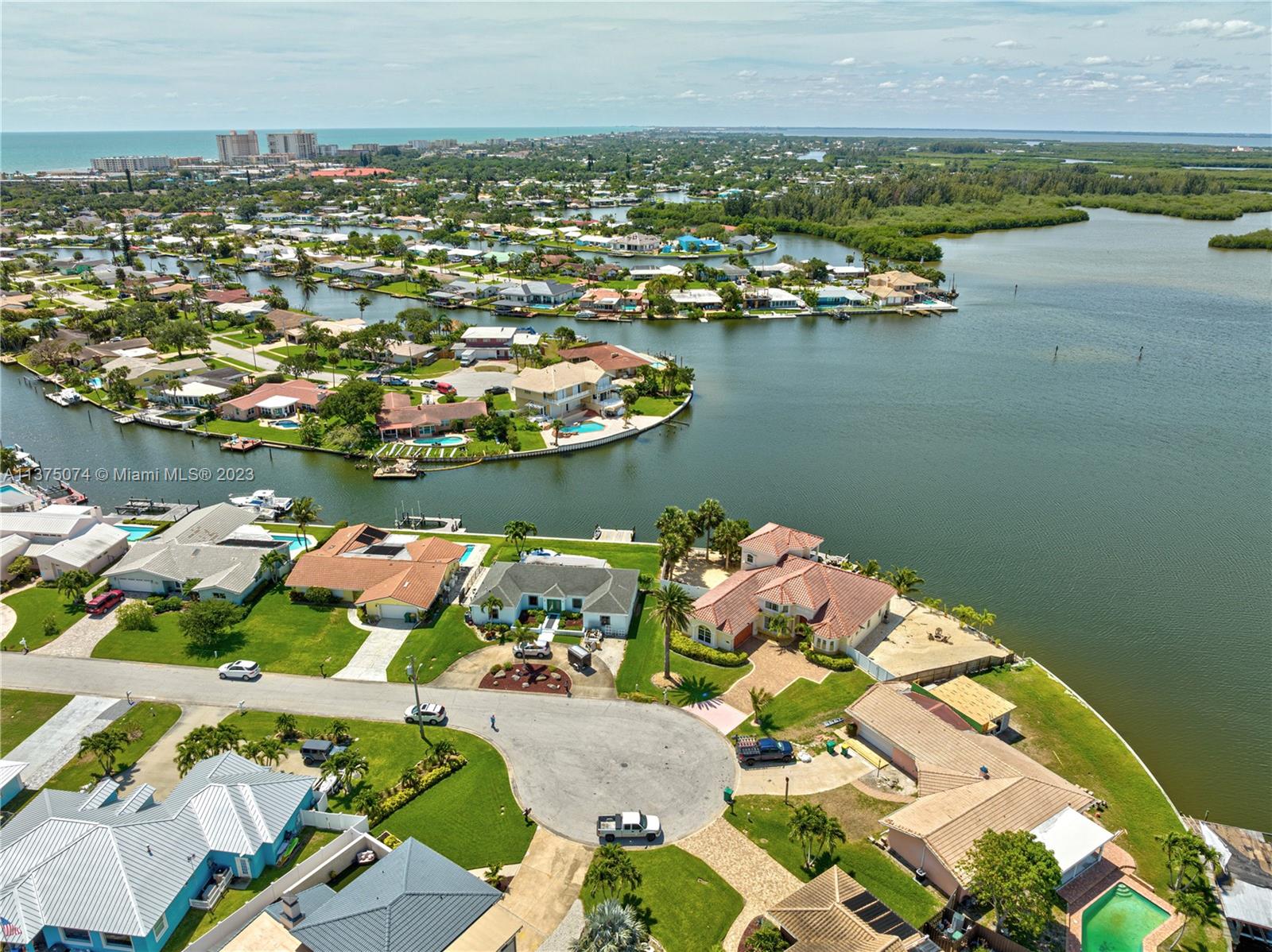 258 Bimini Road Cocoa Beach, FL 32931 - Photo 34 of 43 an aerial view of lake and residential houses with outdoor space