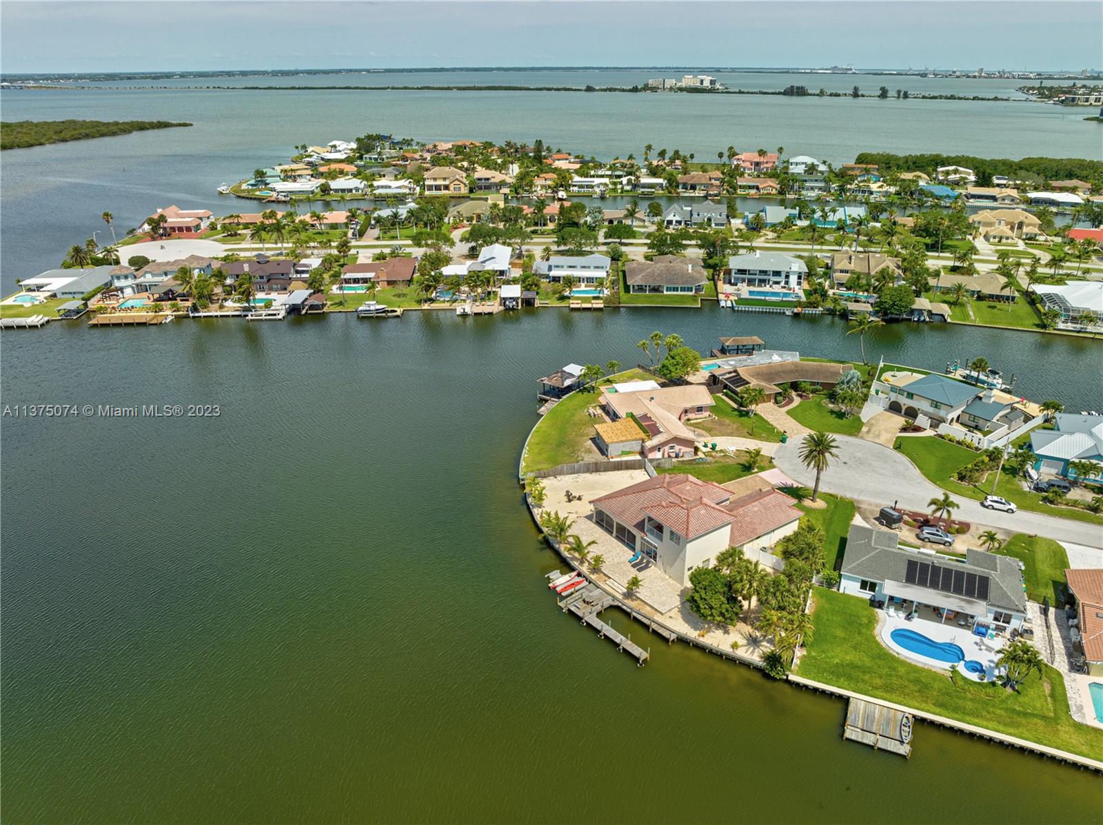 258 Bimini Road Cocoa Beach, FL 32931 - Photo 38 of 43 a view of a lake with a table and chairs