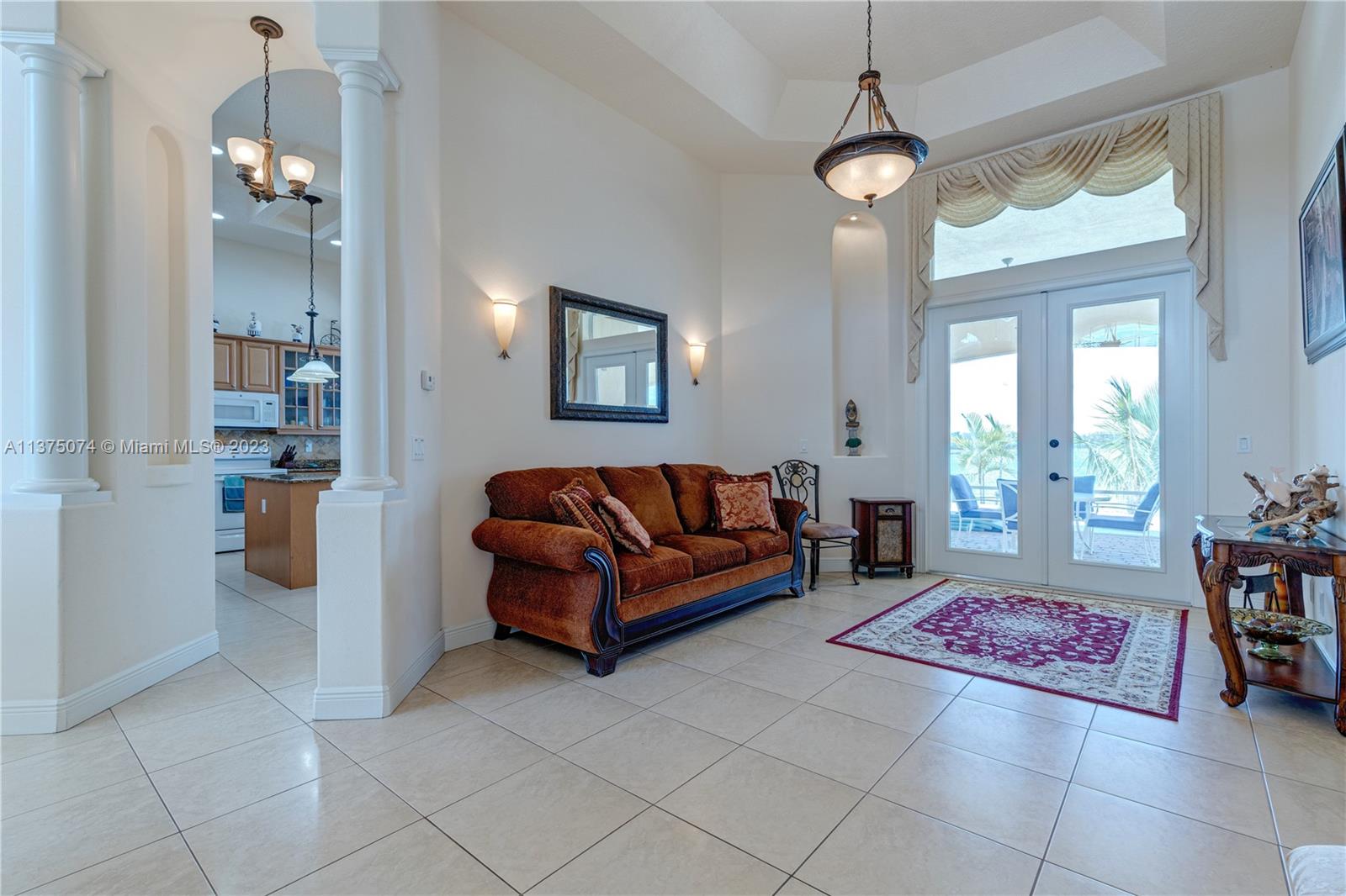 258 Bimini Road Cocoa Beach, FL 32931 - Photo 4 of 43 a living room with furniture and a chandelier