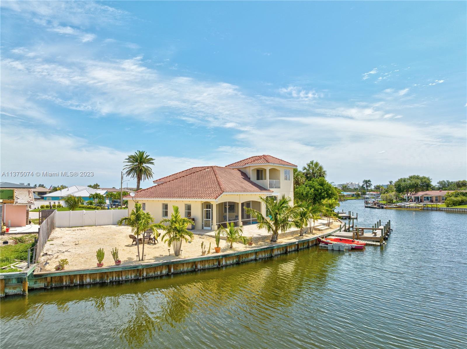 258 Bimini Road Cocoa Beach, FL 32931 - Photo 41 of 43 a view of an ocean with boats and trees in the background