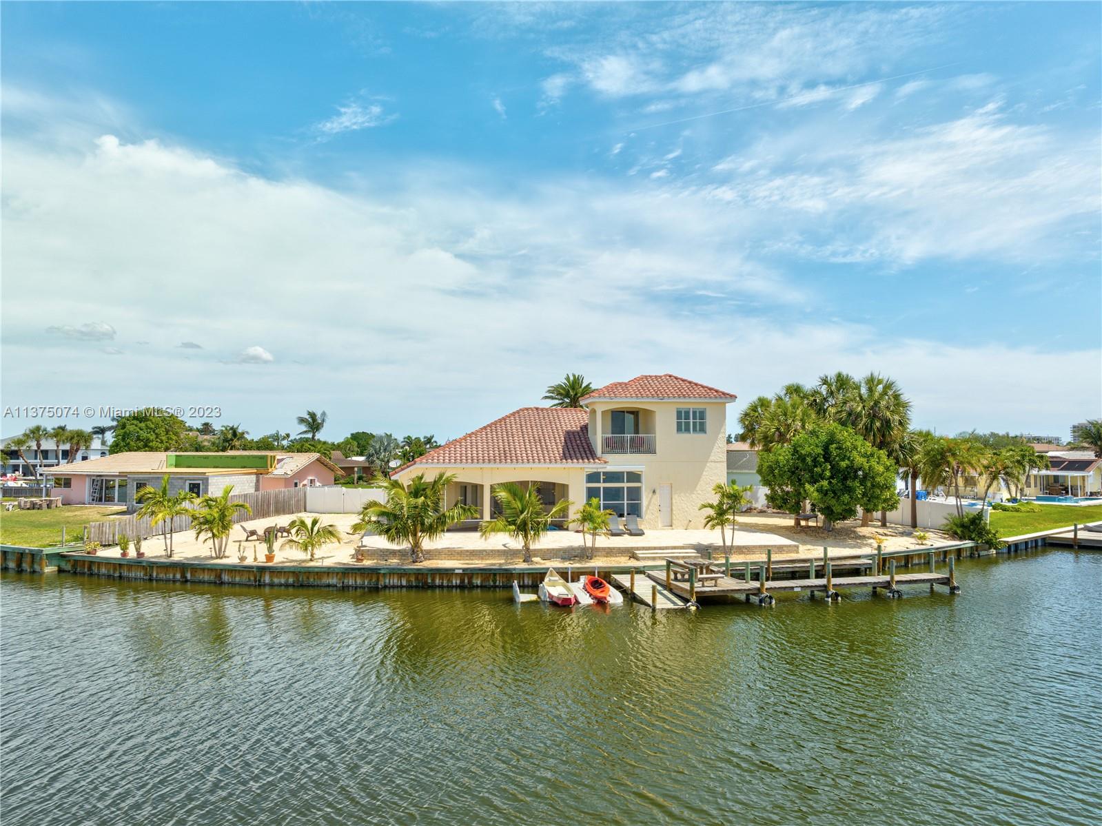 258 Bimini Road Cocoa Beach, FL 32931 - Photo 42 of 43 an aerial view of residential houses with outdoor space and lake view