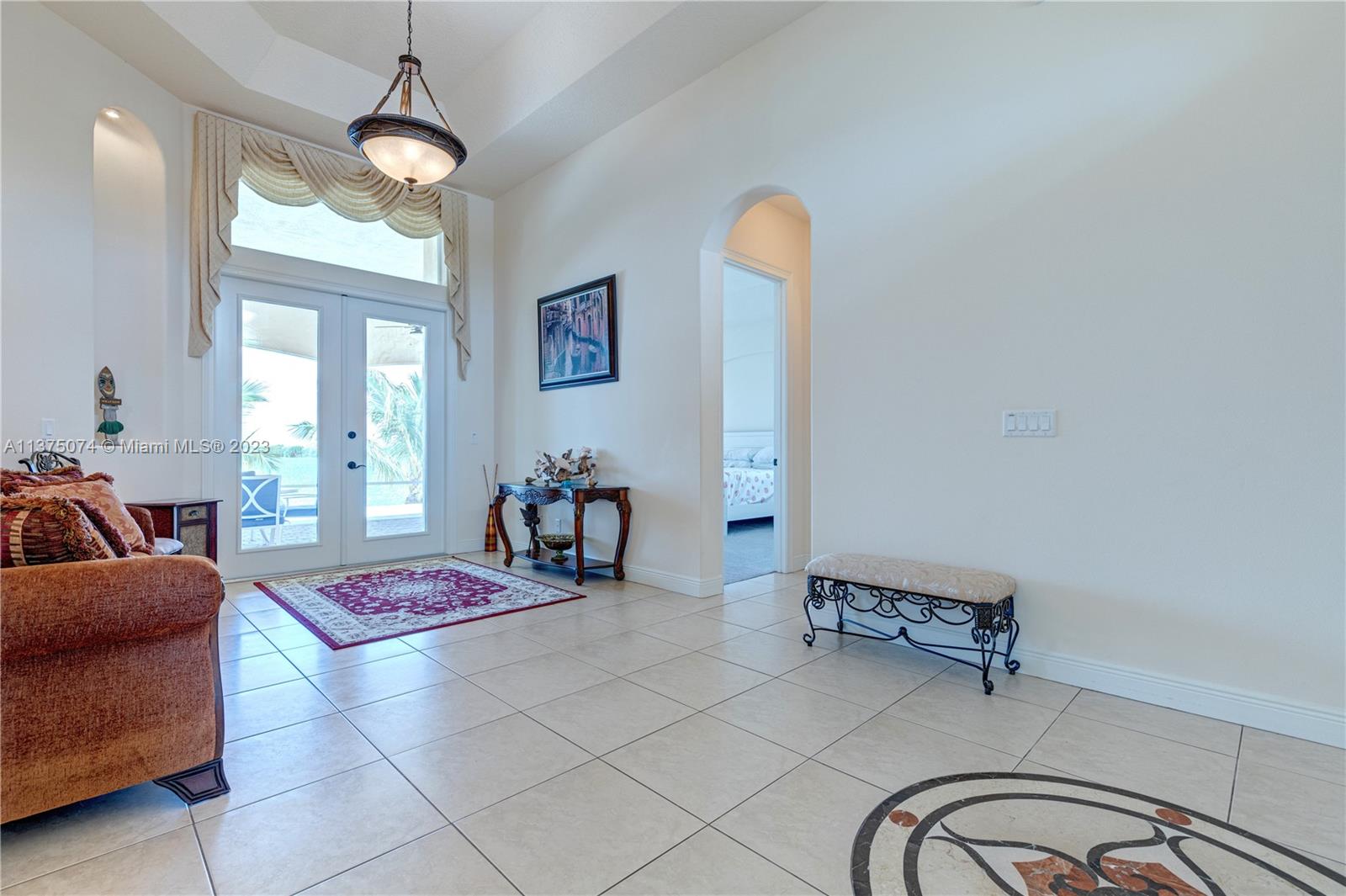 258 Bimini Road Cocoa Beach, FL 32931 - Photo 5 of 43 a bedroom with furniture and a chandelier