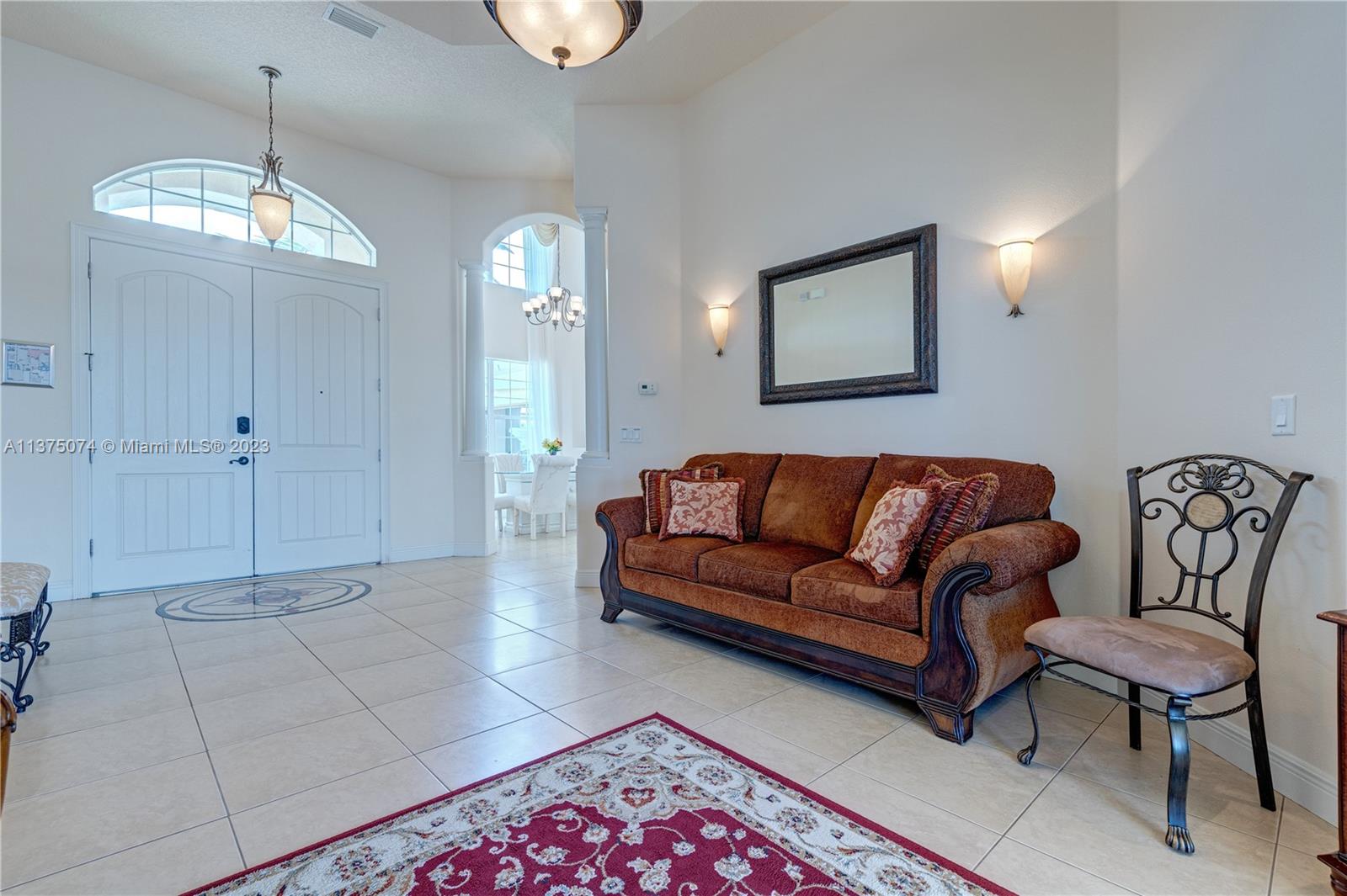 258 Bimini Road Cocoa Beach, FL 32931 - Photo 6 of 43 a living room with furniture and a chandelier