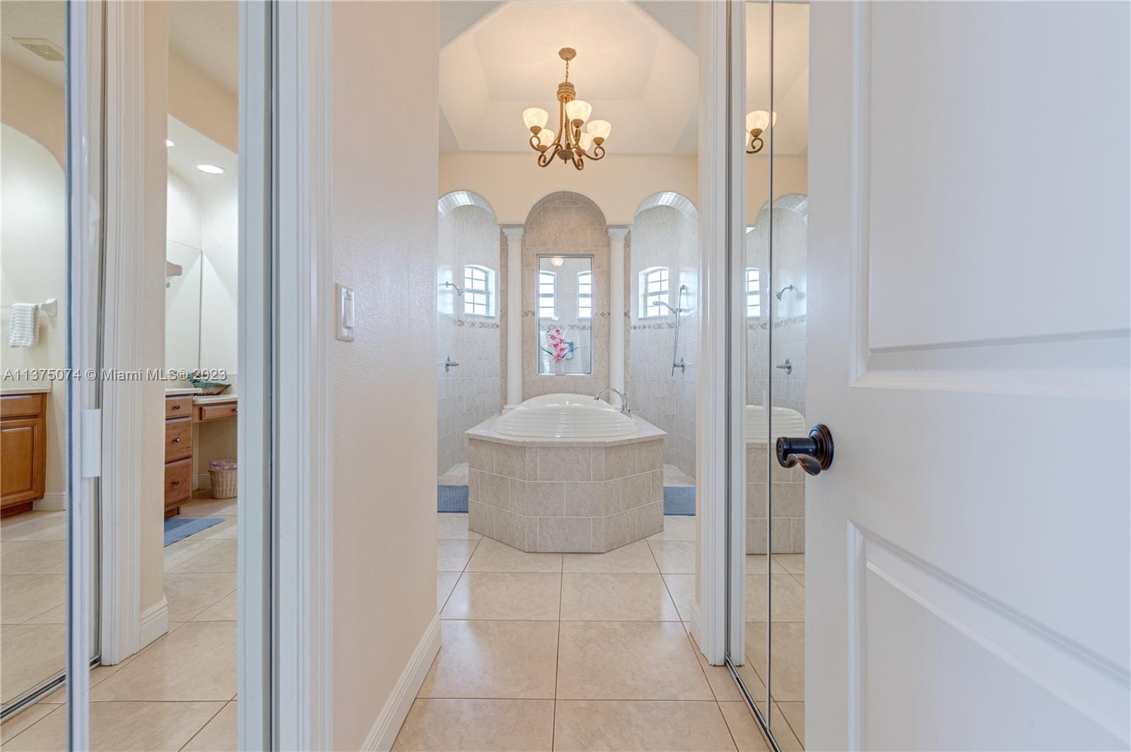 258 Bimini Road Cocoa Beach, FL 32931 - Photo 7 of 43 a bathroom with a mirror and a shower