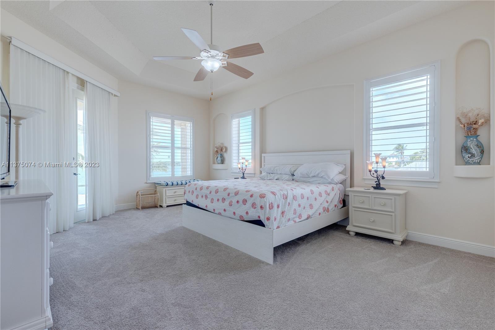 258 Bimini Road Cocoa Beach, FL 32931 - Photo 10 of 43 a bedroom with a bed and a chandelier