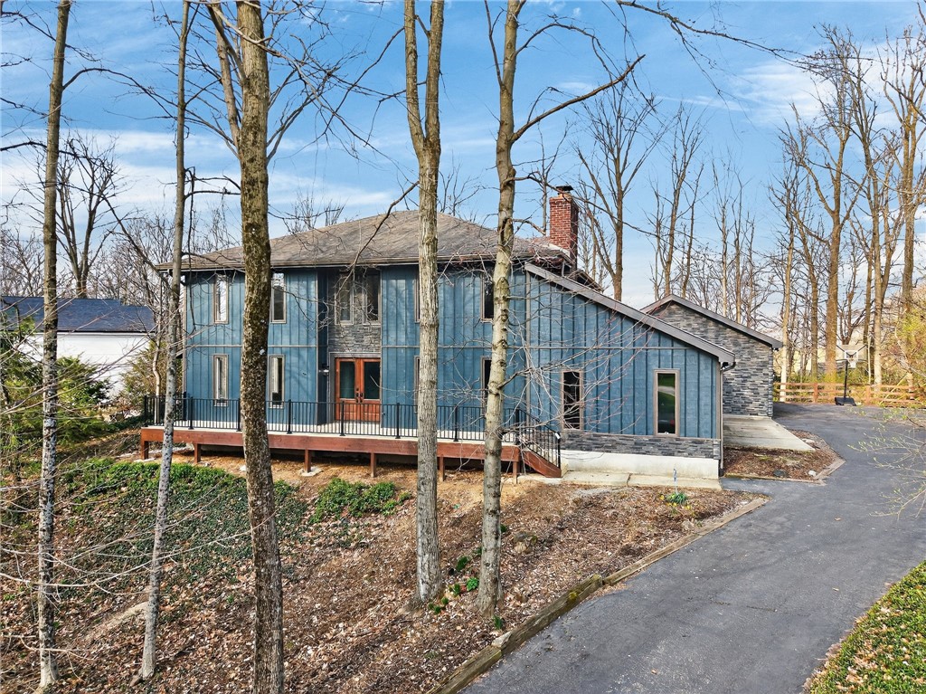 4747 Fawnwood Road Dayton, OH 45429 - Photo 1 of 58 This residence showcases a blend of blue siding and stone, with a charming deck overlooking the natural landscape.