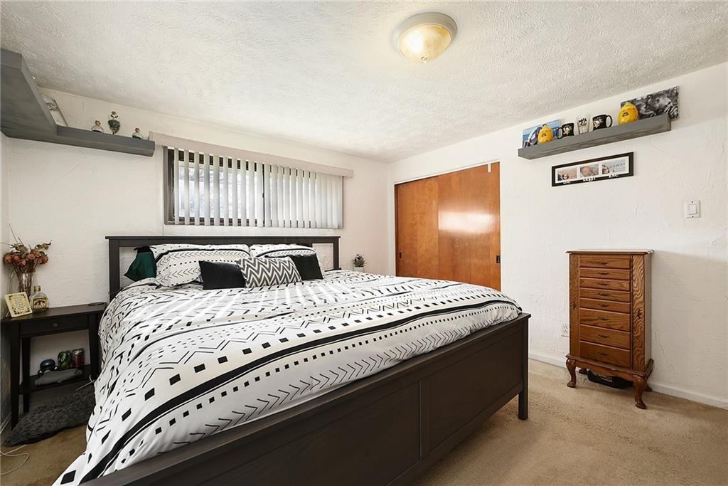 10 Bellview Drive McKees Rocks, PA 15136 - Photo 14 of 25 a bedroom with a bed and a refrigerator