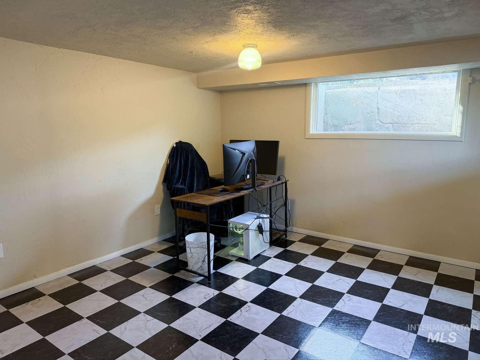 1158 South Powerline Road Nampa, ID 83686 - Photo 42 of 46 Room with checkered tile flooring, light-colored walls, and a window with white trim