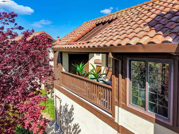 a view of a balcony with flower plants