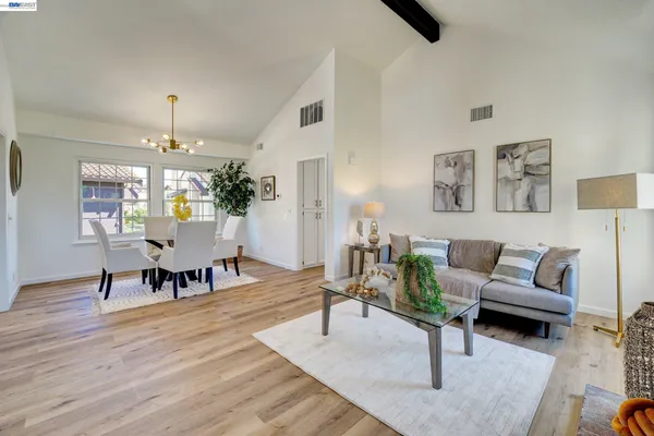 a living room with furniture and a chandelier