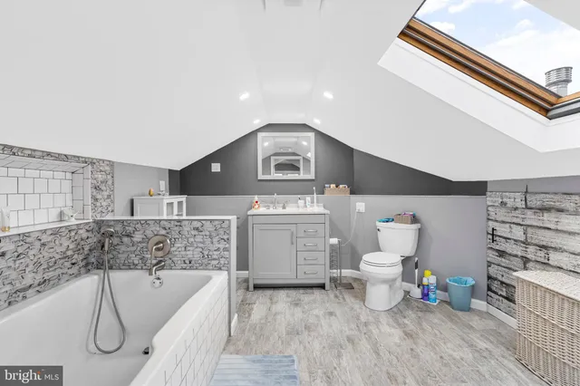 a bathroom with a sink a toilet and bathtub